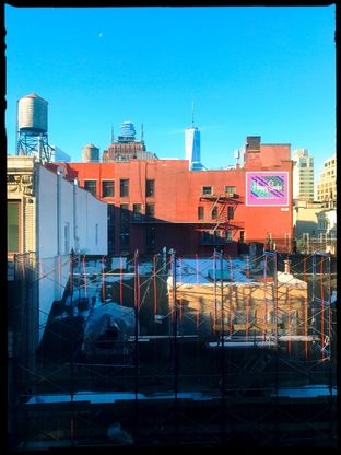 Rooftops and water towers, with One World Trade Center beyond.
