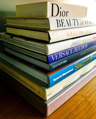 A stack of fashion and photography books.