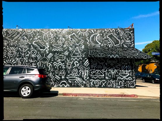 A black-and-white mural covering a building in Los Angeles.