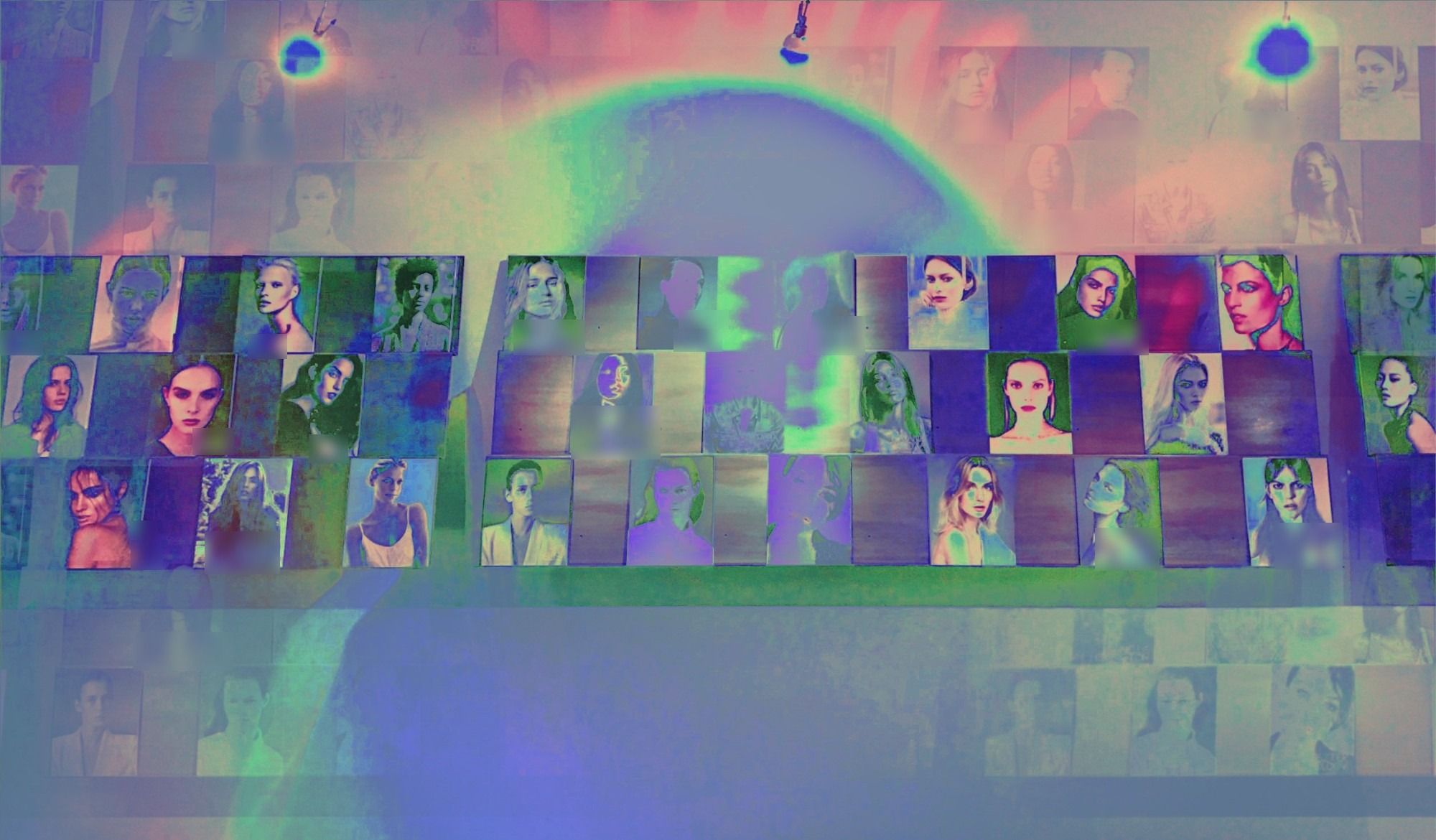 Comp cards on a model agency’s wall, color-treated.